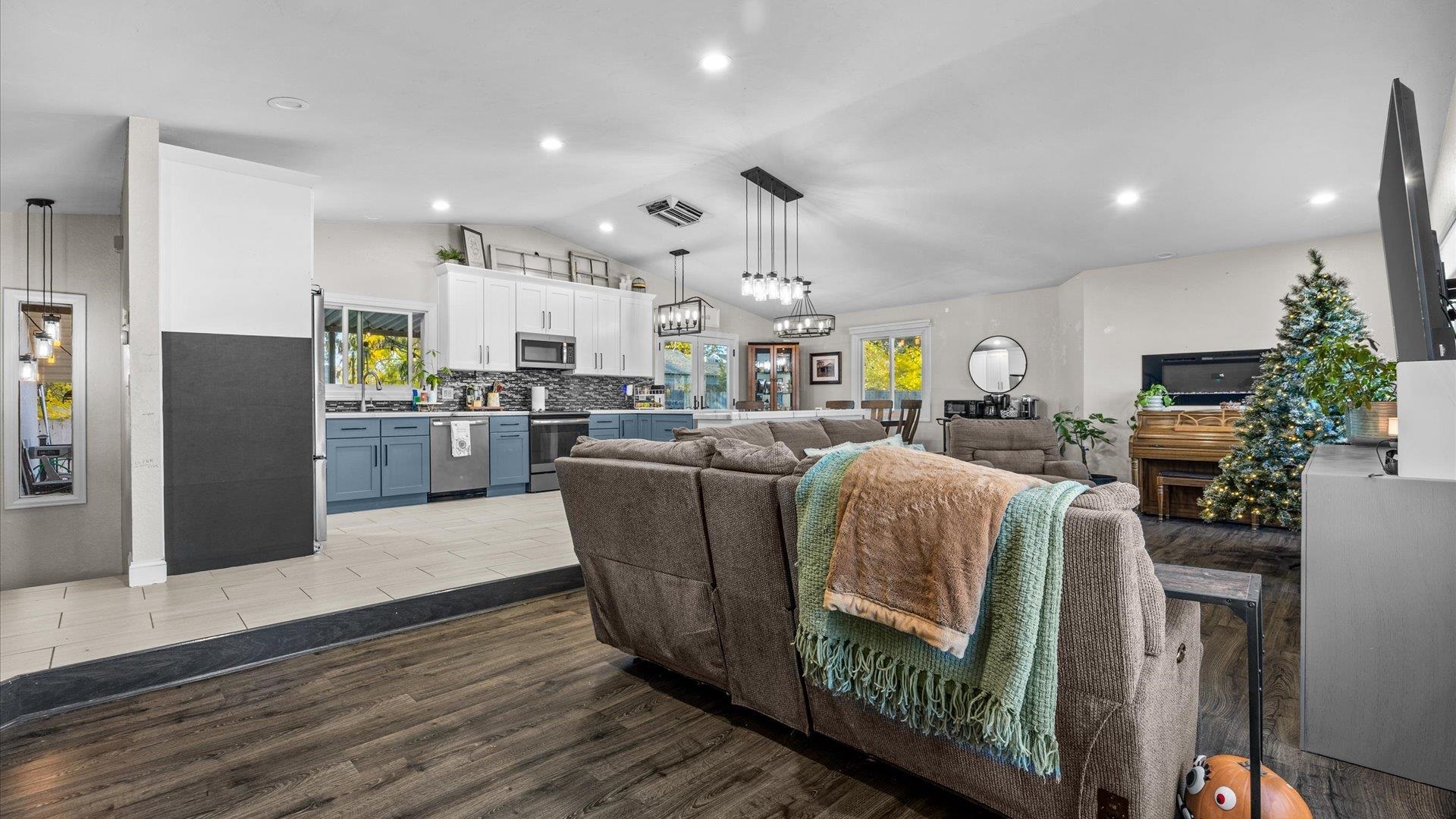 357 Music Lane Grand Junction, CO 81506 - Photo 7 of 29 a living room with stainless steel appliances kitchen island granite countertop furniture wooden floor and a view of kitchen