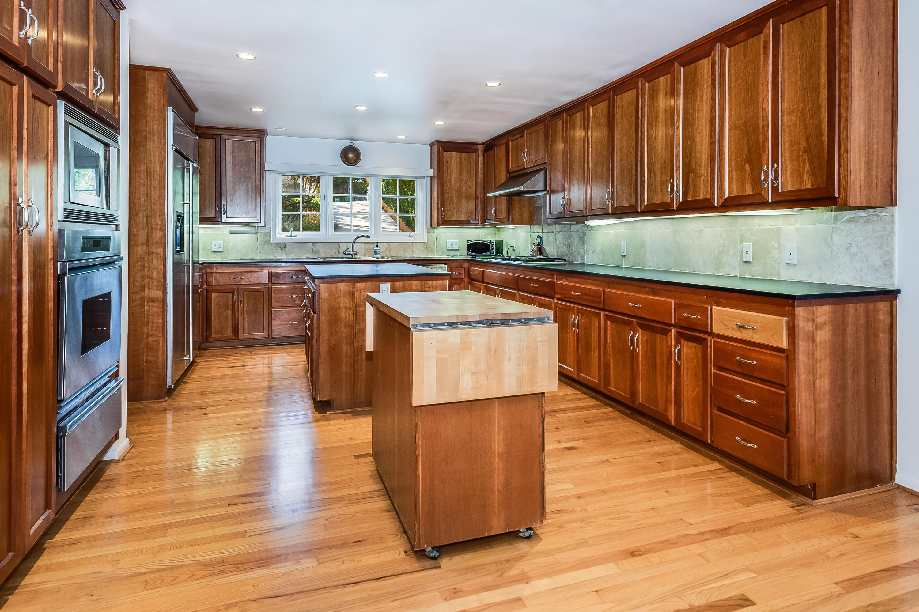 0 Hermosillo Road Montecito, CA 93108 - Photo 4 of 10 a large kitchen with wooden floors stainless steel appliances a sink and a counter space