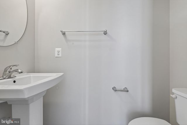 a bathroom with a sink mirror and toilet