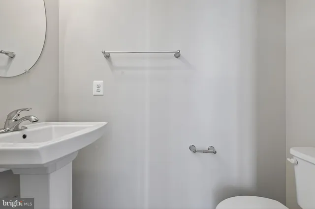 a bathroom with a sink mirror and toilet