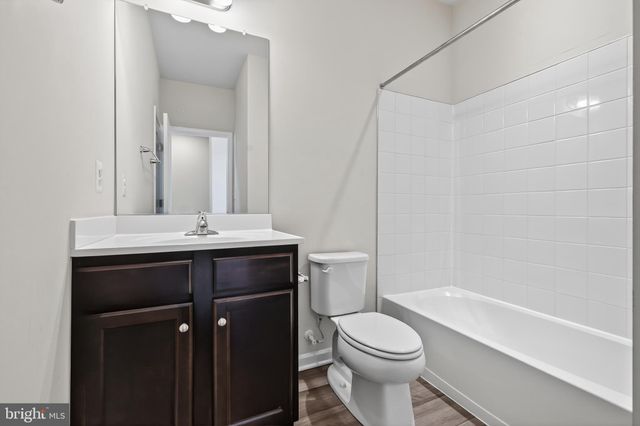 a bathroom with a sink toilet vanity and shower