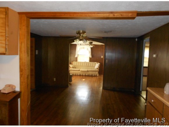 4788 Cameron Road Hope Mills, NC 28348 - Photo 11 of 17 a view of a hallway with wooden floor and a fireplace