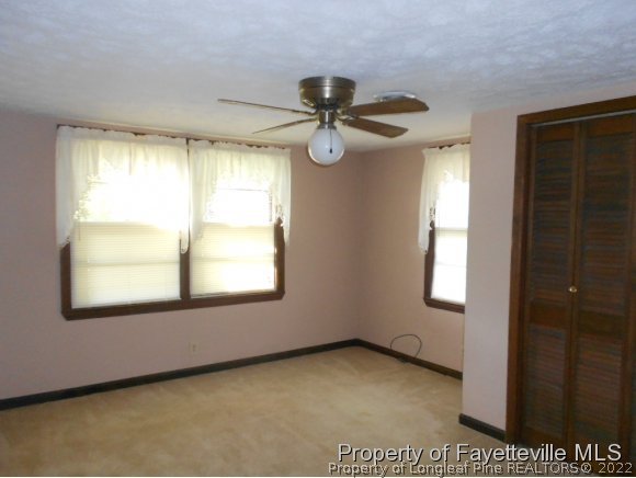 4788 Cameron Road Hope Mills, NC 28348 - Photo 12 of 17 a view of a livingroom with a window and a ceiling fan