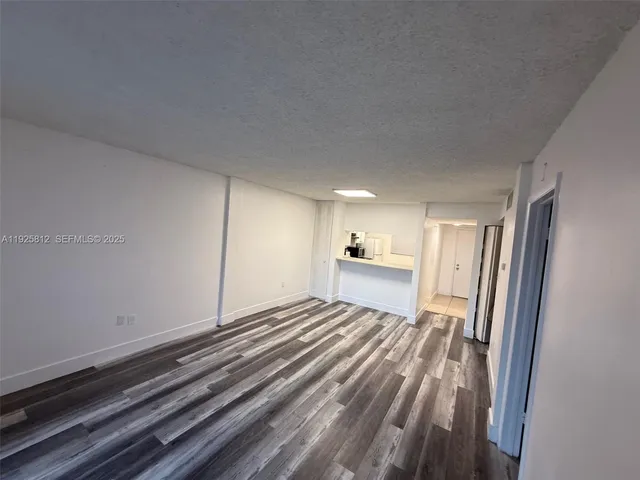 a view of a room with wooden floor and window