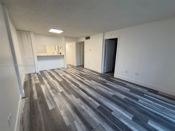 a view of wooden floor in an empty room