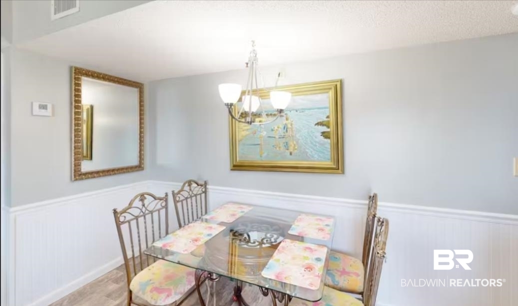 375 Plantation Road, Unit 5814 Gulf Shores, AL 36542 - Photo 5 of 31 Dining area with light hardwood / wood-style floors and a textured ceiling