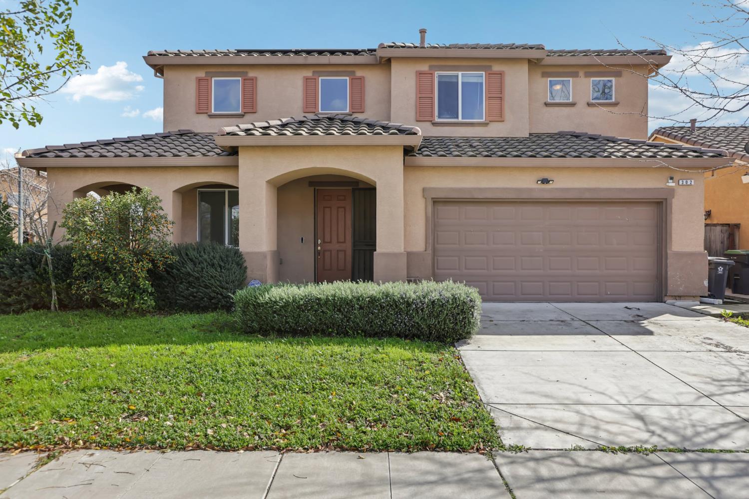 302 Johnson Ferry Road Lathrop, CA 95330 - Photo 1 of 1 a front view of a house with garden
