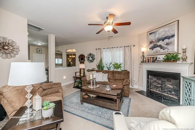 a living room with furniture and a fireplace