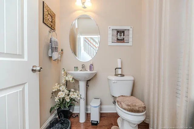 a bathroom with a toilet sink and mirror