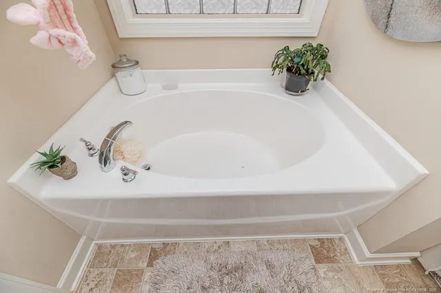 a bath tub sitting next to a white sink