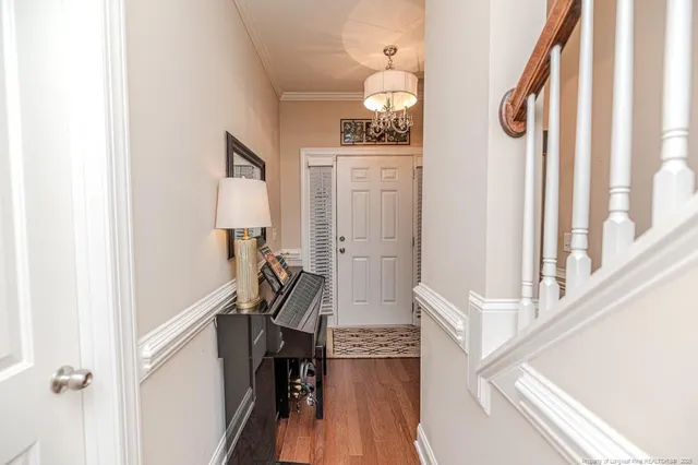 a view of a hallway with wooden floor and staircase