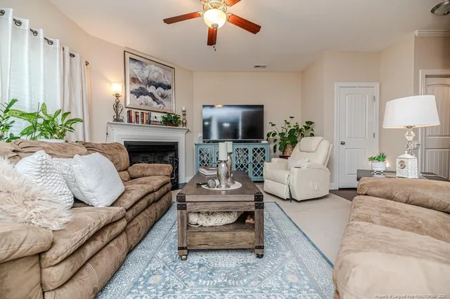 a living room with furniture and a fireplace