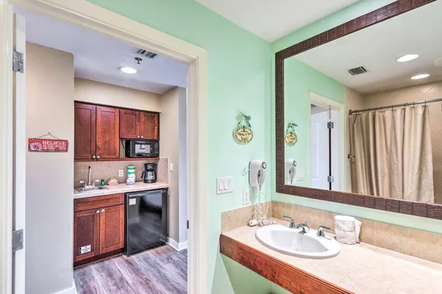 a en suite bathroom with a sink double vanity and a mirror