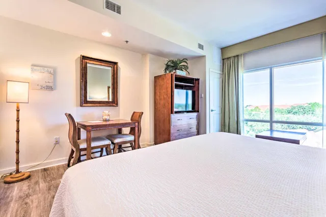 a bedroom with a bed table and chair