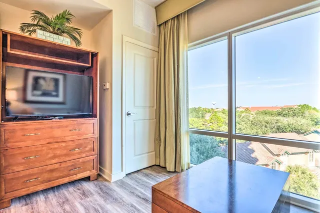 a view of a living room and a window with wooden floor