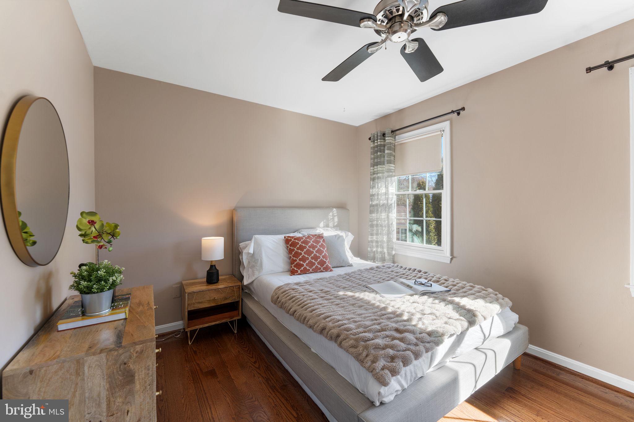 6140 Ramshorn Drive McLean, VA 22101 - Photo 22 of 72 a bedroom with a bed chandelier and a window