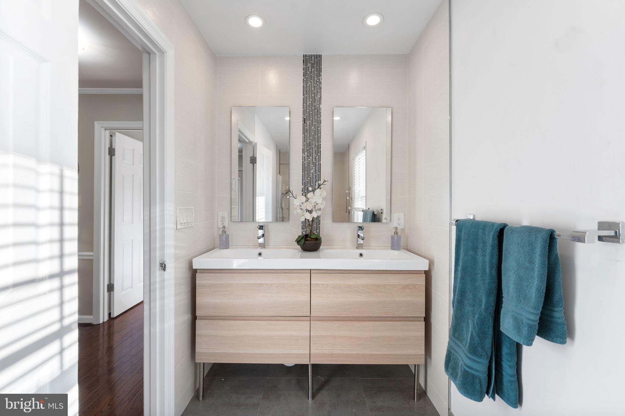 6140 Ramshorn Drive McLean, VA 22101 - Photo 27 of 72 a bathroom with a sink vanity and a mirror