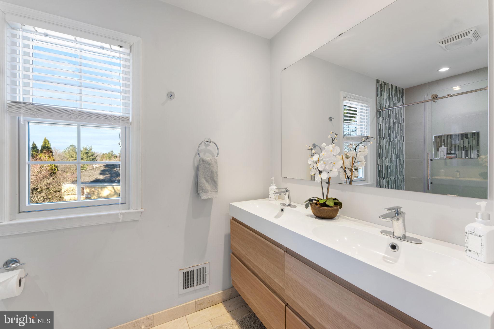 6140 Ramshorn Drive McLean, VA 22101 - Photo 34 of 72 a bathroom with a double vanity sink and mirror