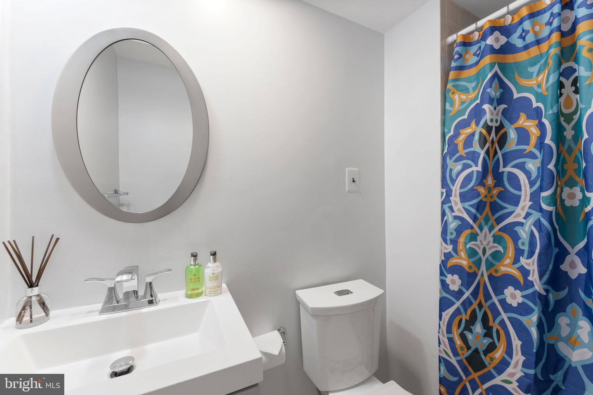 6140 Ramshorn Drive McLean, VA 22101 - Photo 40 of 72 a bathroom with a sink and a mirror