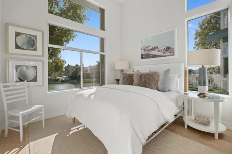 a bed room with a bed and a chair