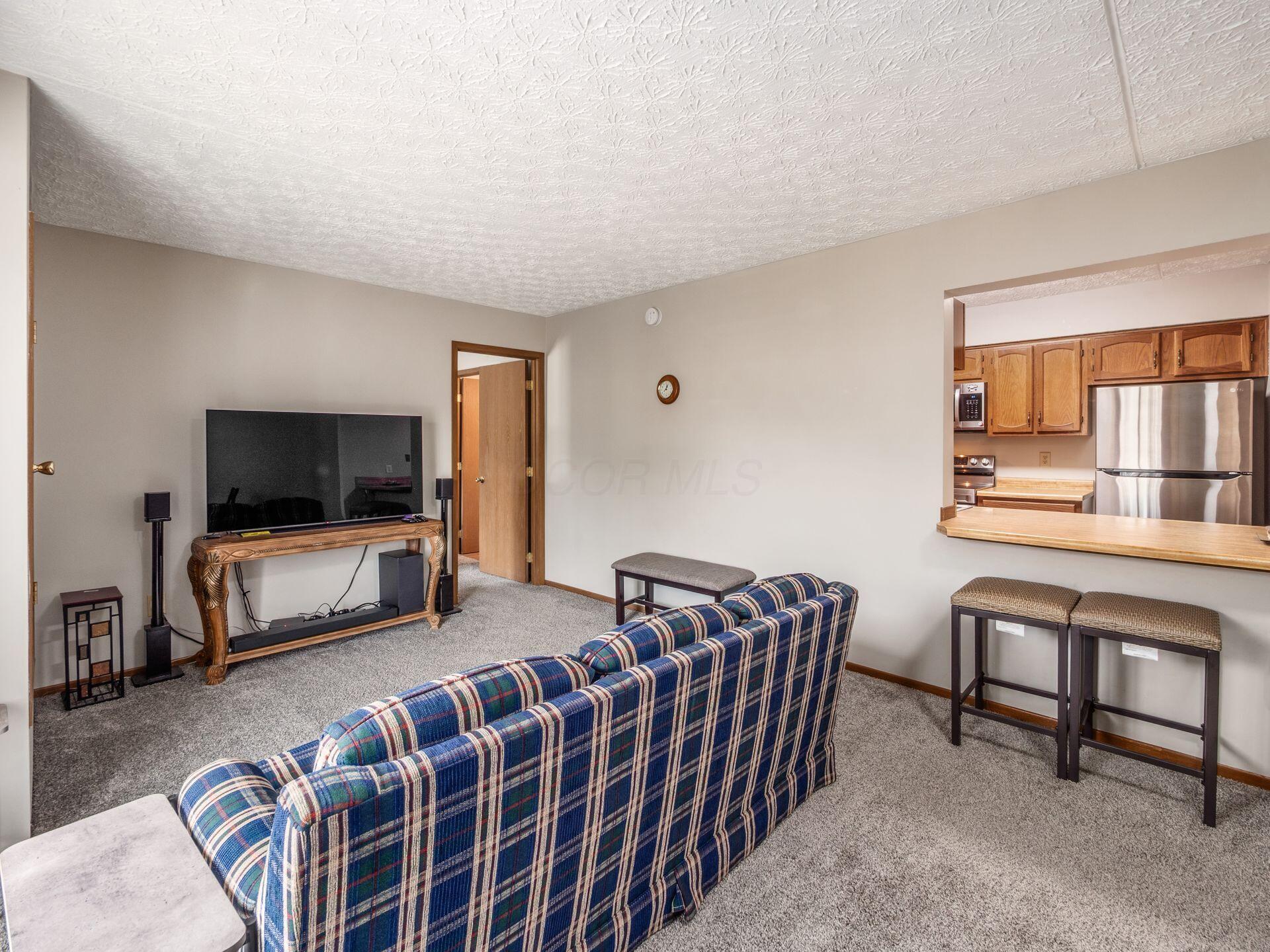opening to kitchen with stool seating