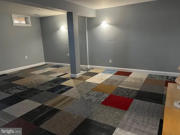 a view of a livingroom with wooden floor and a rug