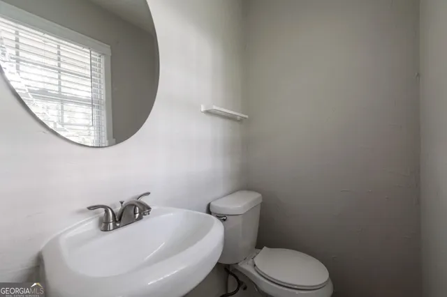 a bathroom with a sink a mirror and a toilet