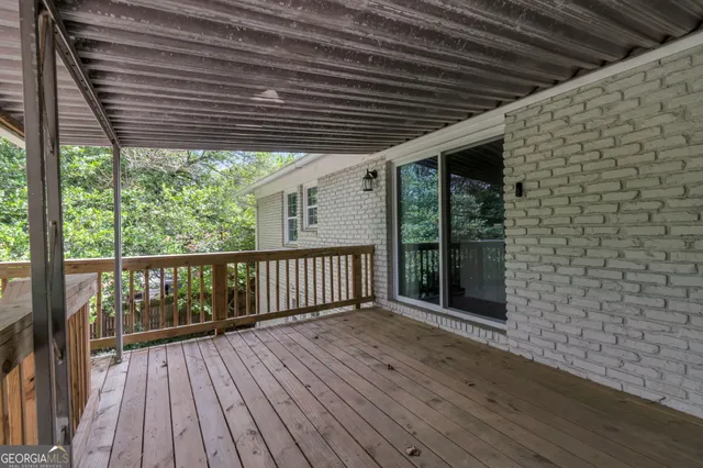 a porch with wooden floor in front of a house
