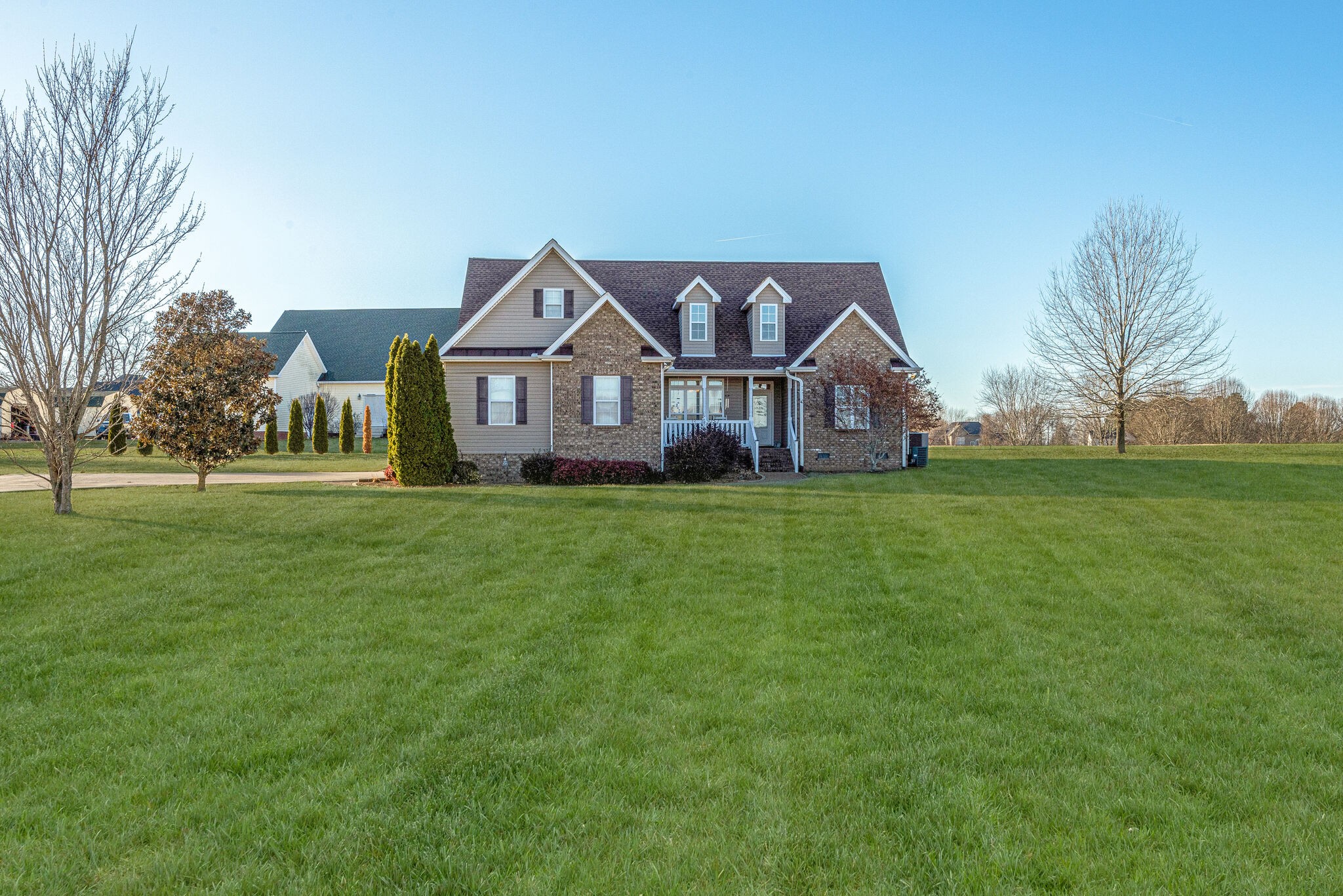 1686 Porter Road Bon Aqua, TN 37025 - Photo 1 of 28 a front view of a house with a yard and trees