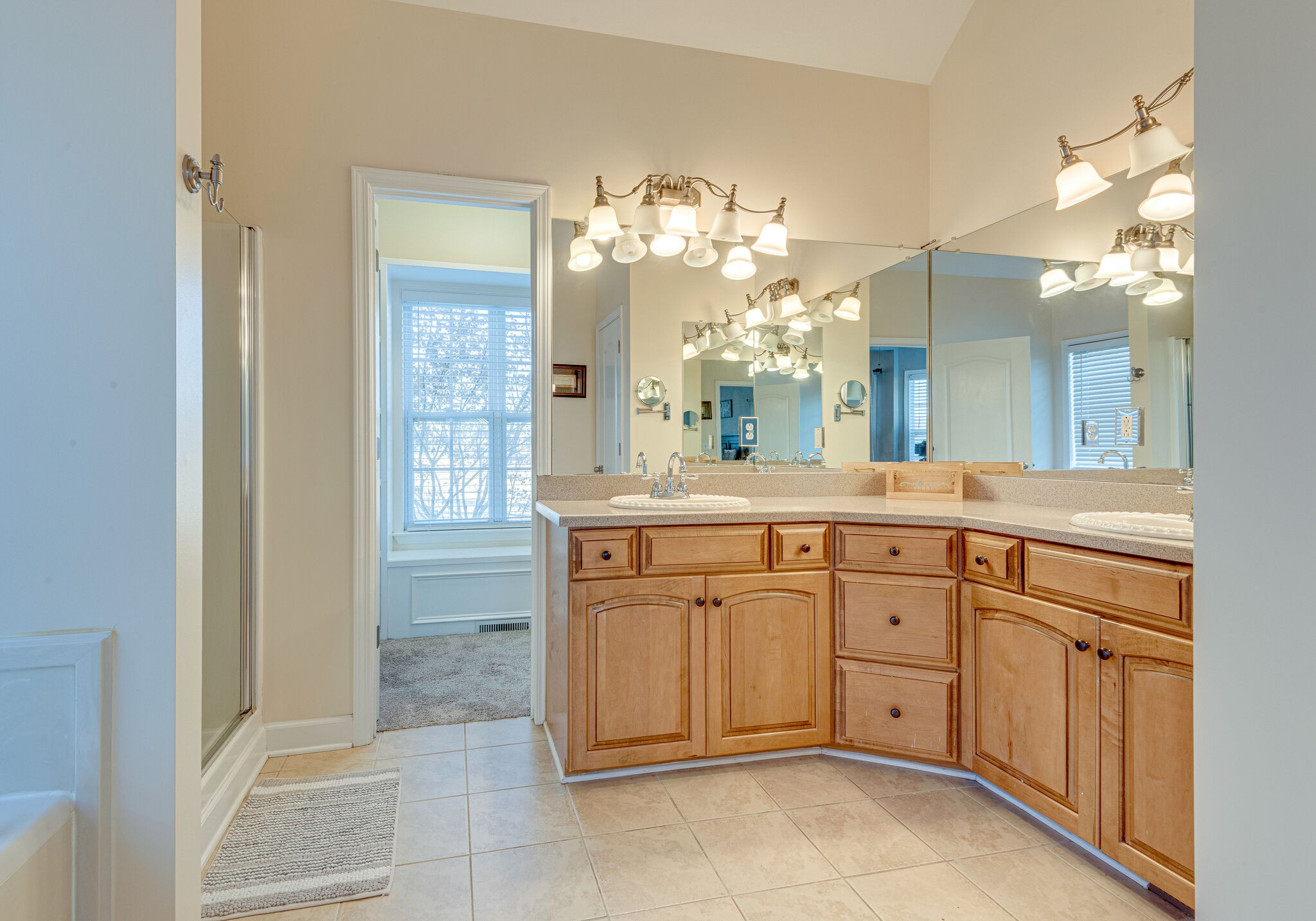 1686 Porter Road Bon Aqua, TN 37025 - Photo 18 of 28 a spacious bathroom with a granite countertop sink a mirror and a