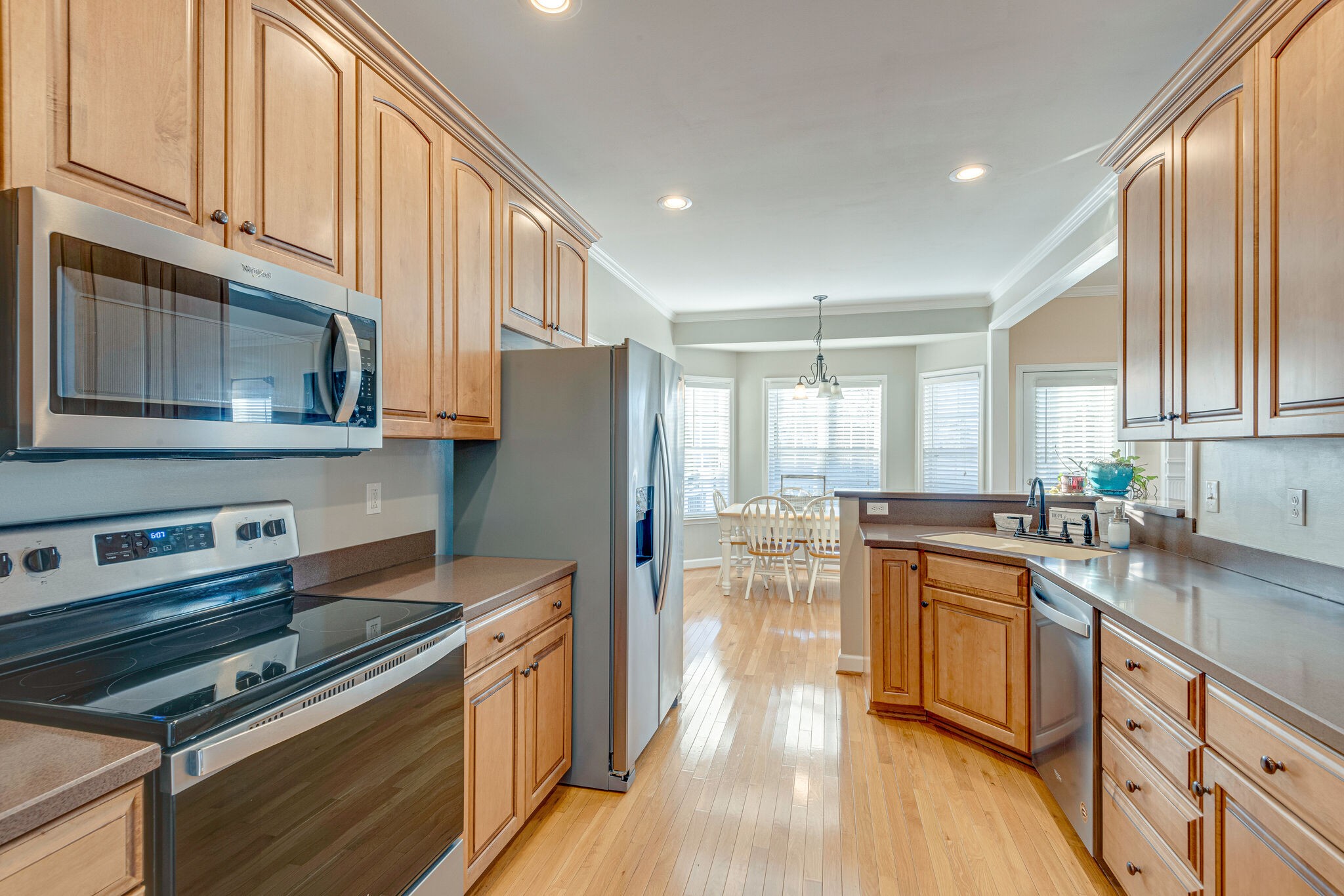 1686 Porter Road Bon Aqua, TN 37025 - Photo 10 of 28 a kitchen with stainless steel appliances a stove a sink dishwasher a refrigerator white cabinets and wooden floor