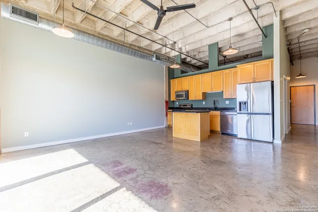 a view of a kitchen with a refrigerator and a stove