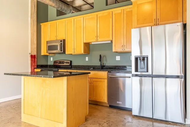 a kitchen with stainless steel appliances a sink and a window