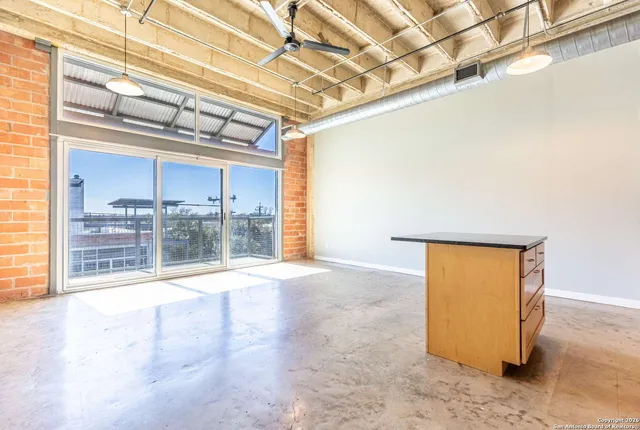 a view of an empty room and a window
