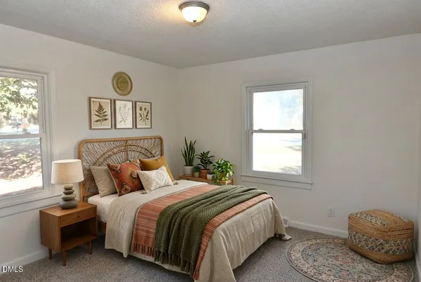 a bedroom with a bed and window