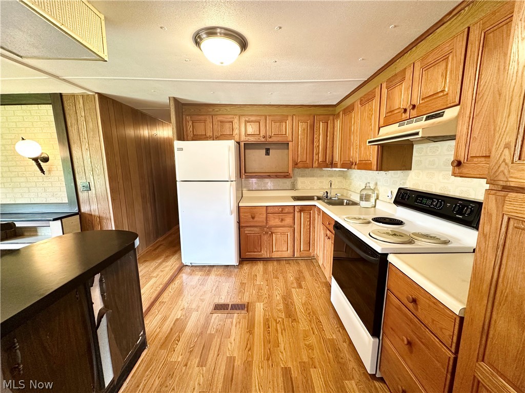 28 Richter Road Colliers, WV 26035 - Photo 7 of 38 Eat-in kitchen featuring hardwood floors and appliances
