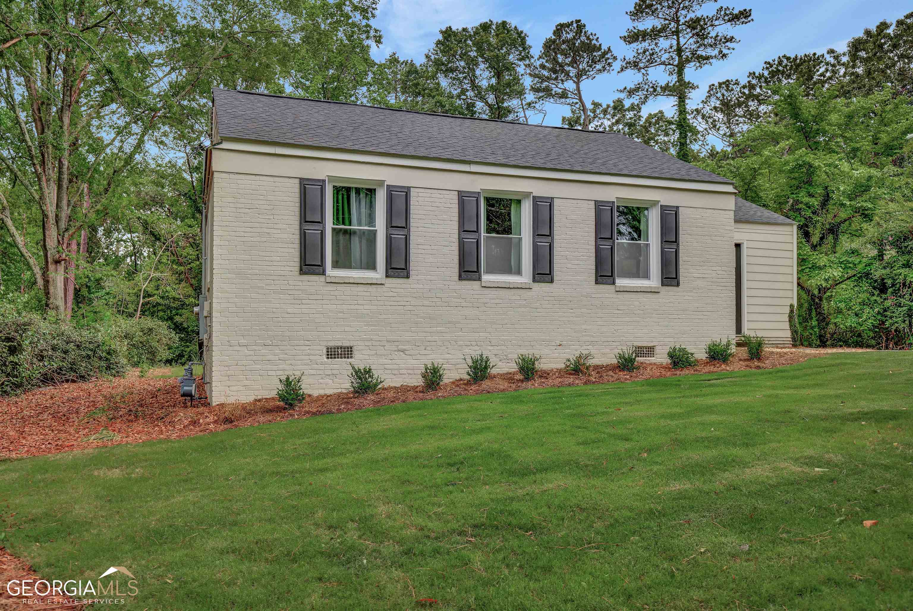a house that has a big yard in front of it
