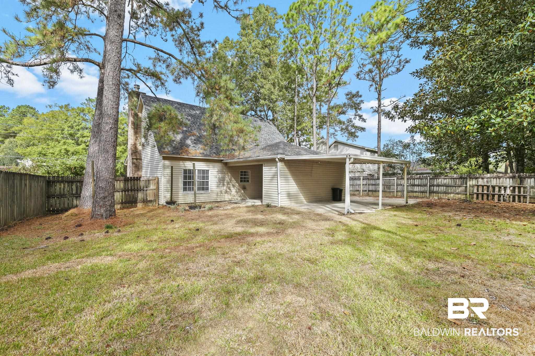 474 Ridgewood Drive Daphne, AL 36526 - Photo 51 of 57 Back of house featuring a patio area and a lawn