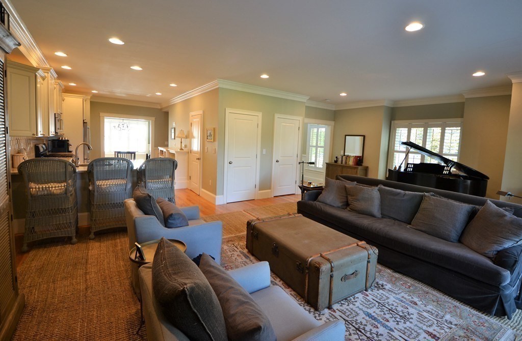 a living room with furniture ceiling fan and a rug