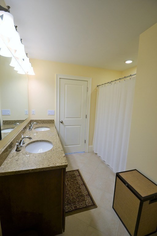 11 Tufts Road, Unit 11 Winchester, MA 01890 - Photo 12 of 18 a bathroom with a sink and a mirror