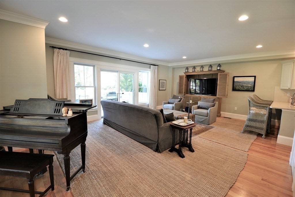 11 Tufts Road, Unit 11 Winchester, MA 01890 - Photo 2 of 18 a living room with furniture and a flat screen tv