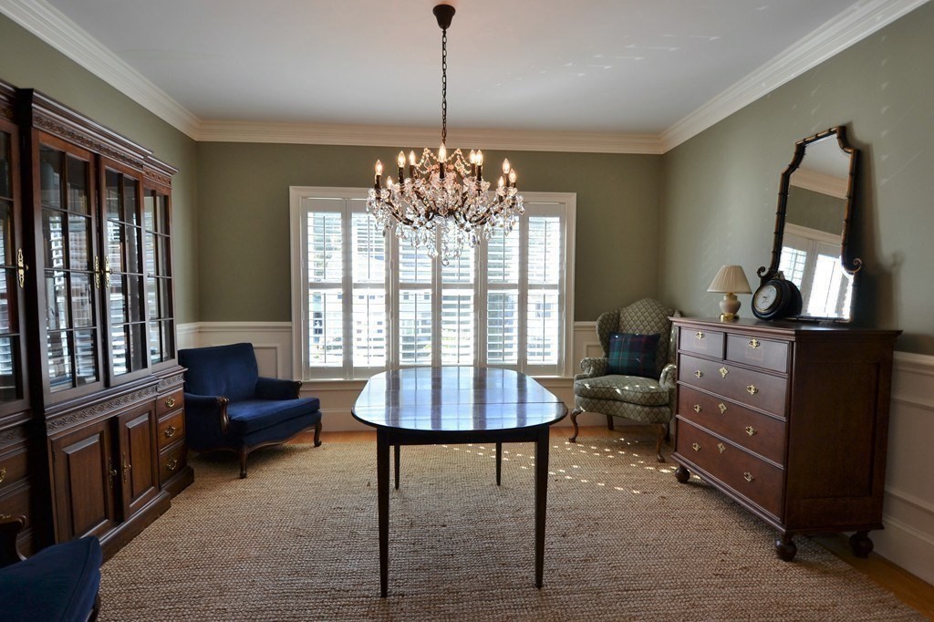 11 Tufts Road, Unit 11 Winchester, MA 01890 - Photo 5 of 18 a living room with furniture and a chandelier