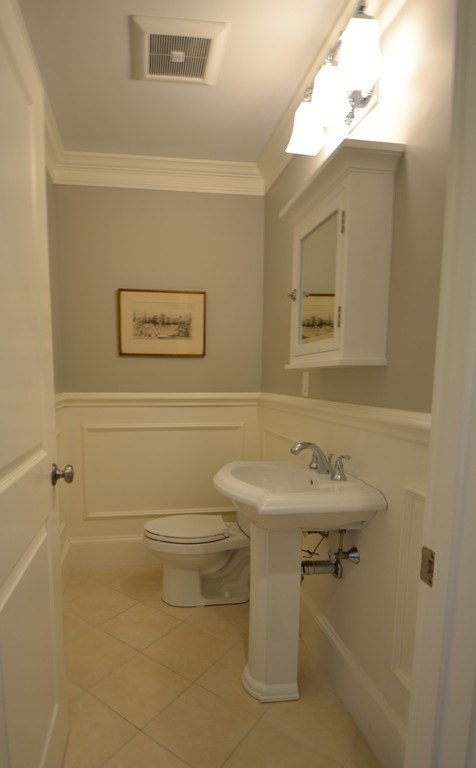 11 Tufts Road, Unit 11 Winchester, MA 01890 - Photo 7 of 18 a bathroom with a sink a toilet and mirror