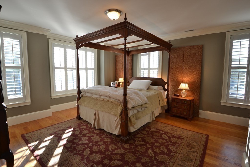 11 Tufts Road, Unit 11 Winchester, MA 01890 - Photo 8 of 18 a bedroom with a bed lamp closet and large window