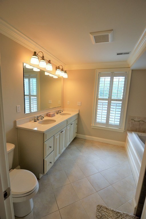 11 Tufts Road, Unit 11 Winchester, MA 01890 - Photo 9 of 18 a bathroom with a sink a toilet and mirror