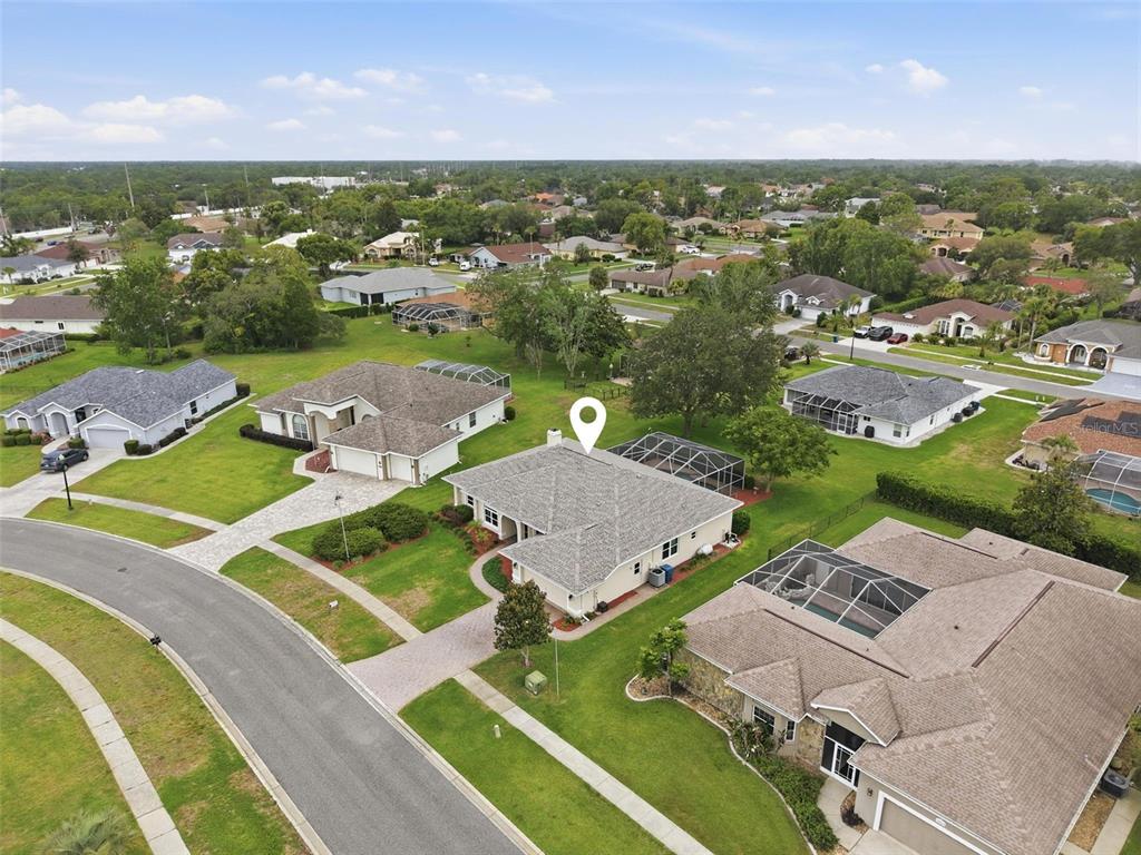 14228 Presteign Lane Spring Hill, FL 34609 - Photo 88 of 89 an aerial view of residential houses with outdoor space and a lake view