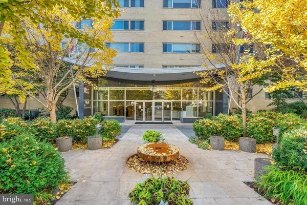 a view of a building with garden and flowers