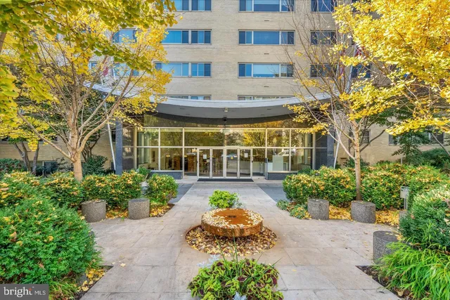 a view of a building with garden and flowers