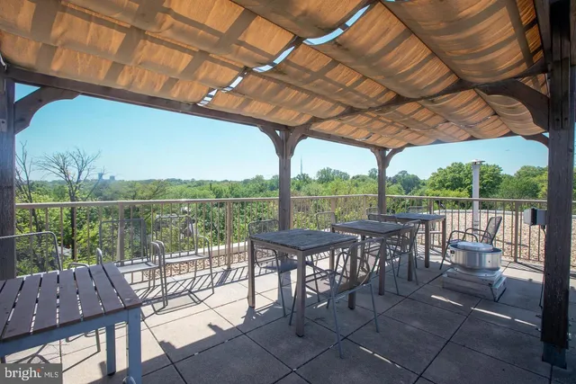 a view of a patio with chairs and a table