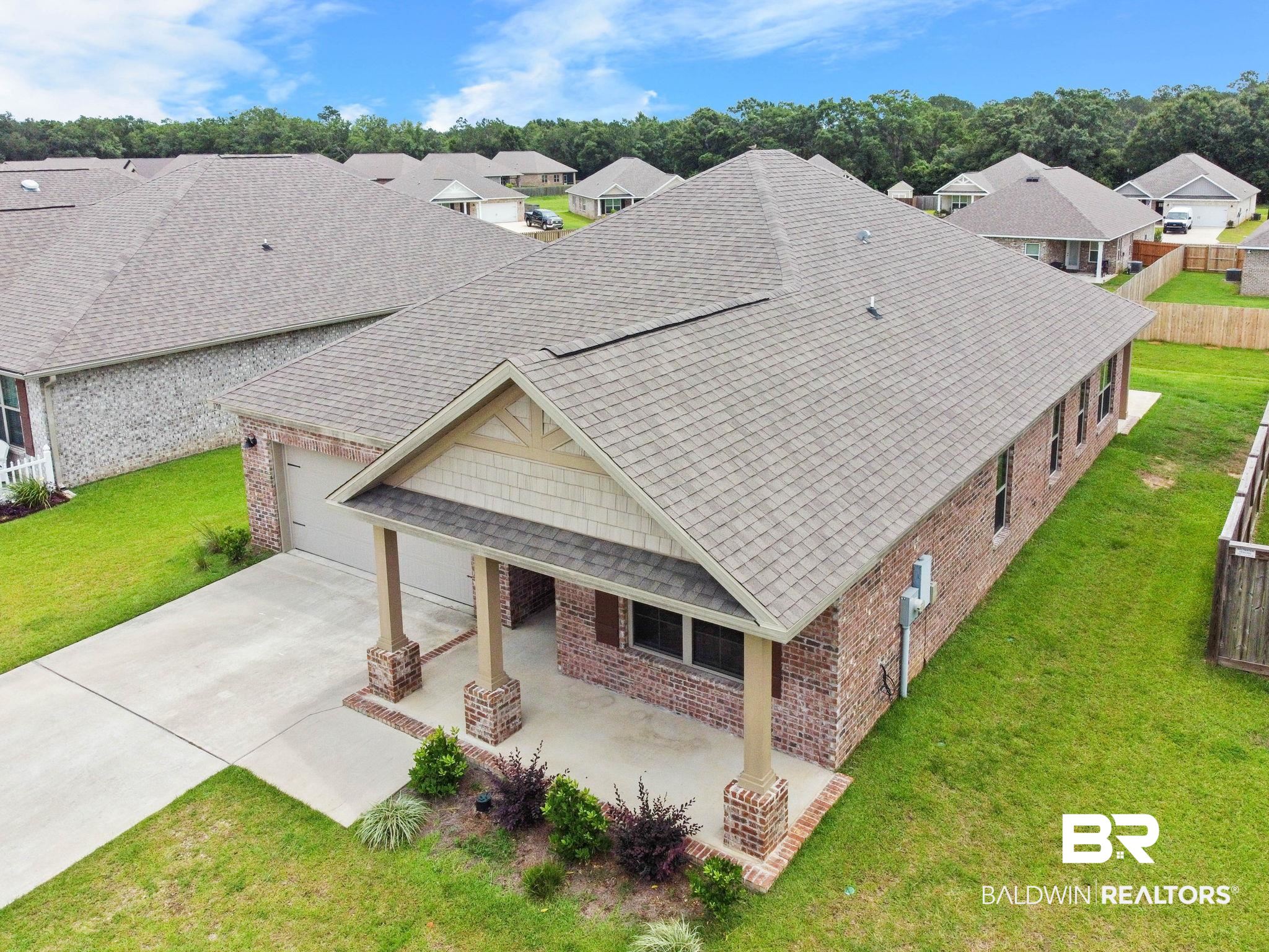 1710 Grouse Street Foley, AL 36535 - Photo 6 of 76 Brick exterior with a covered porch, two-car garage, and concrete driveway